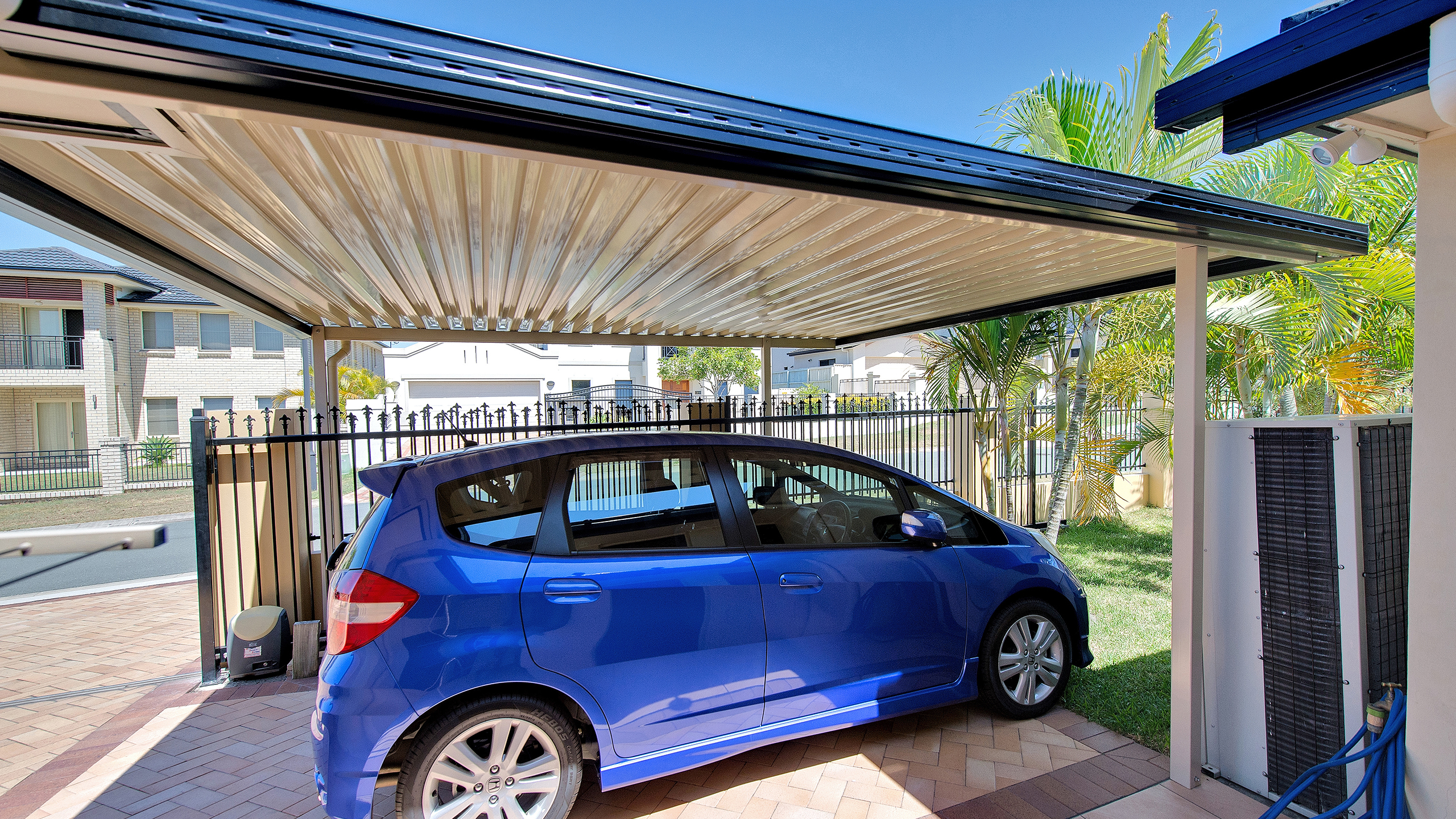 A single carport built by Altec with a car in driveway